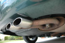Dual exhaust pipes attached to a car's muffler